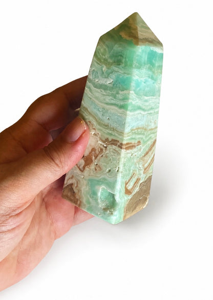 Blue-green smithsonite crystal obelisk styled for stress relief and heart chakra healing